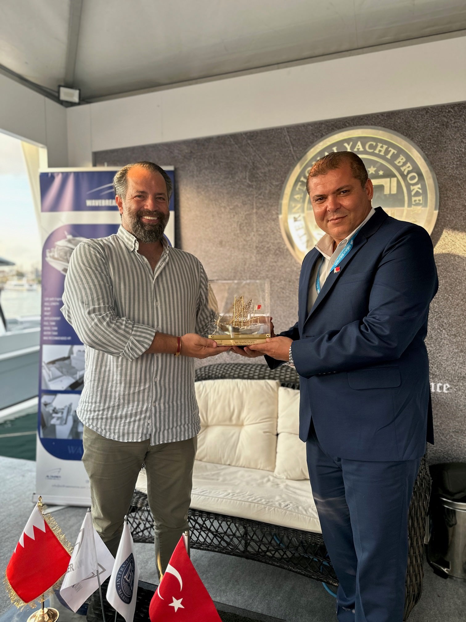 Two men holding an award